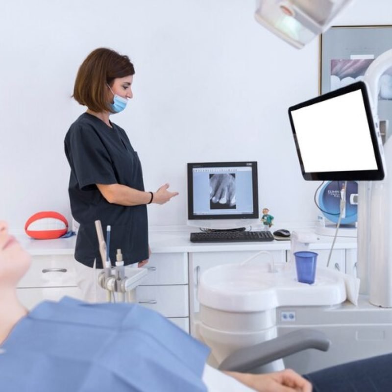 female-dentist-showing-teeth-xray-computer-clinic_23-2147879118